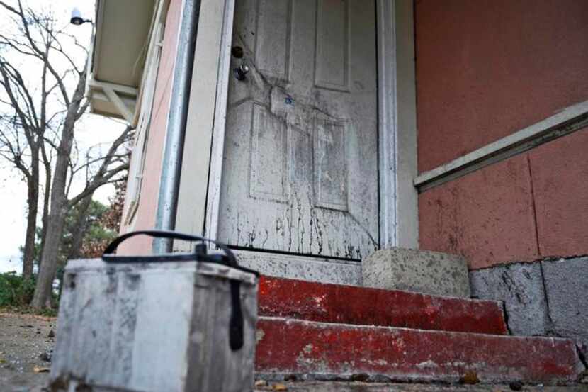 
The imprint of a car battery could be seen Friday on the door of a house in the 500 block...