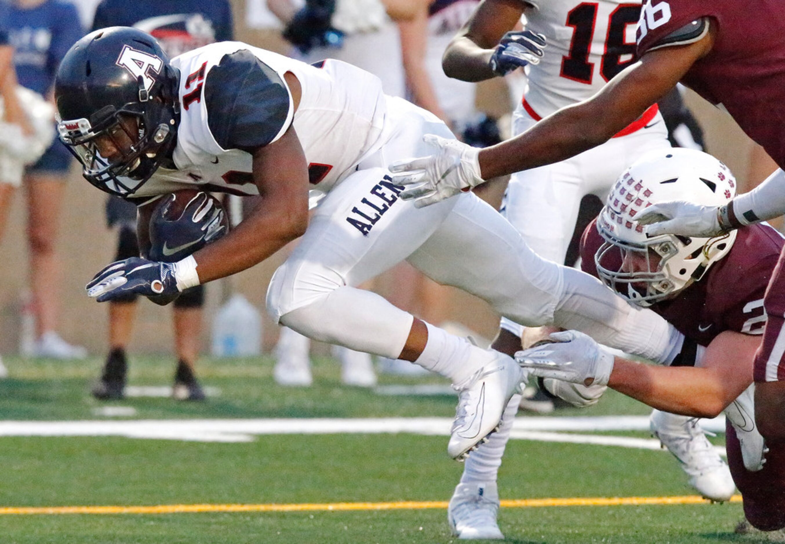 Allen High School running back Jordan Johnson (11) lunges to get across the goal line during...