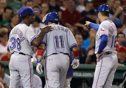FILE - The Rangers' Bengie Molina (11) gets a pat on the back from manager Ron Washington...