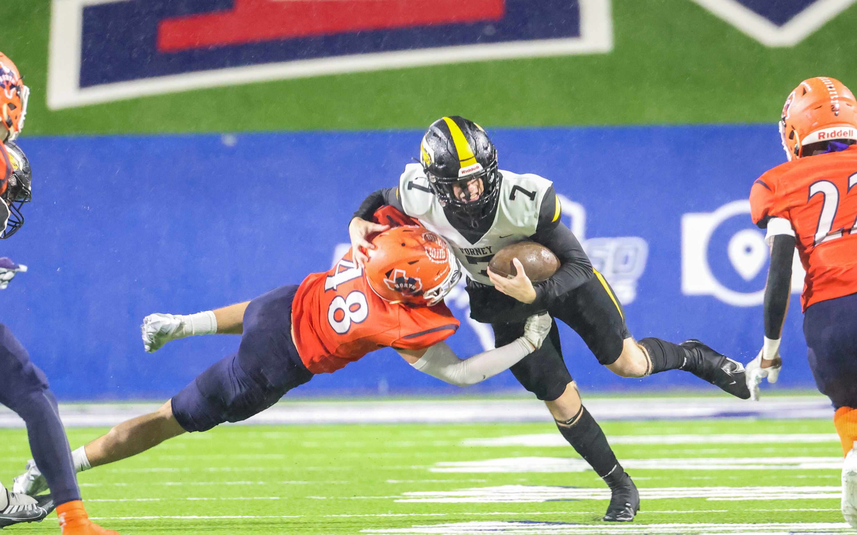 Forney quarterback Brent Paine (7) is tackled by McKinney North line backer Grayson Rogers...
