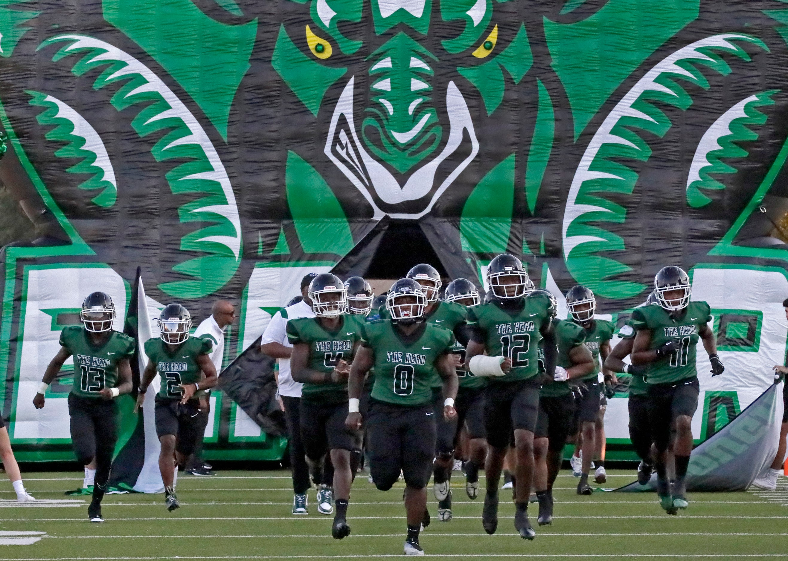 The Berkner High School football team takes the field before kickoff as Berkner High School...