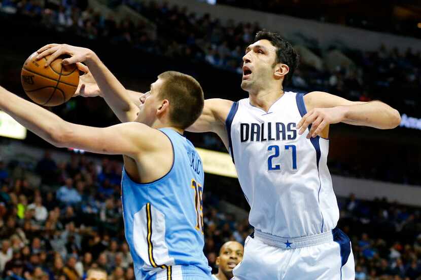 Dallas Mavericks center Zaza Pachulia (27) has his shot stripped away by Denver Nuggets...