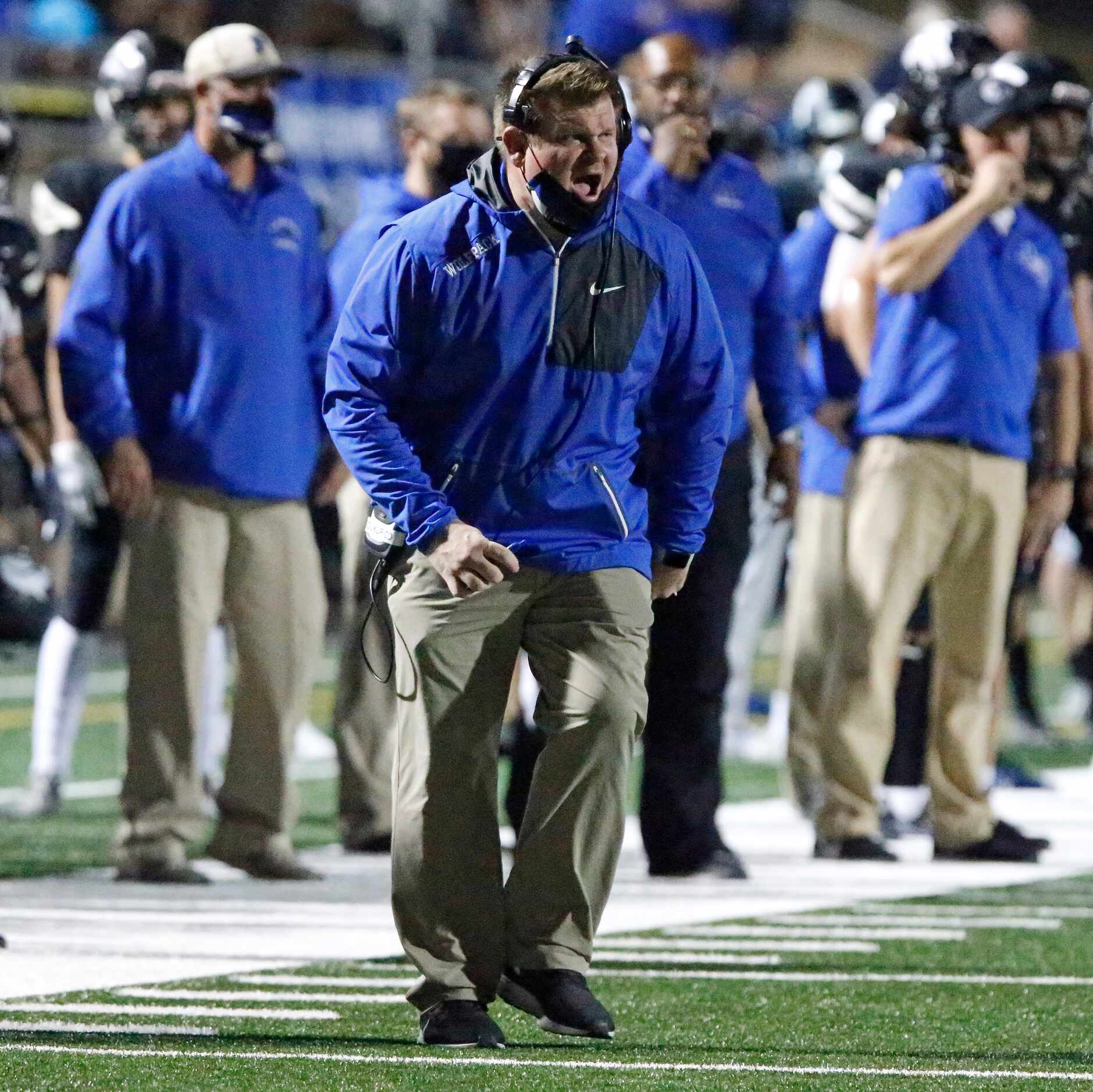 Plano West High School head coach Tyler Soukup calls out to his team during the first half...