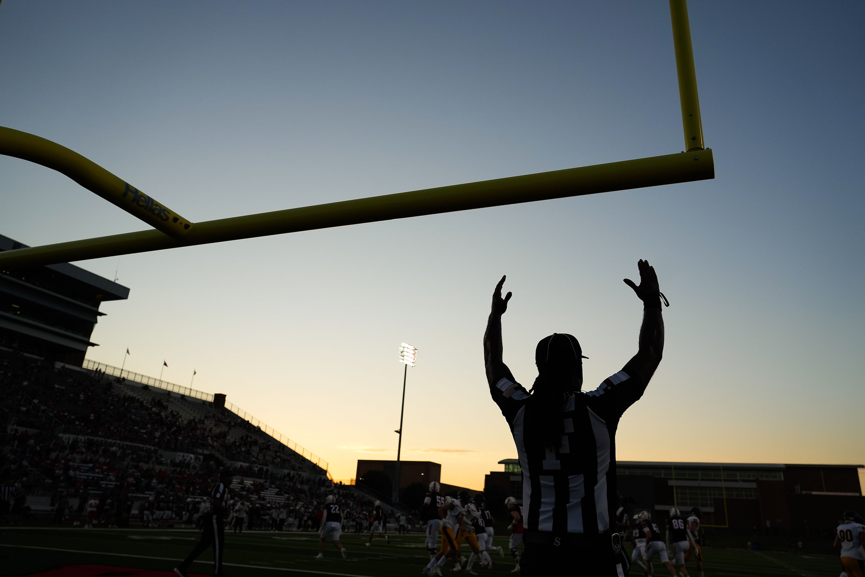 Officials signal a made point after try during the first half of a high school football game...