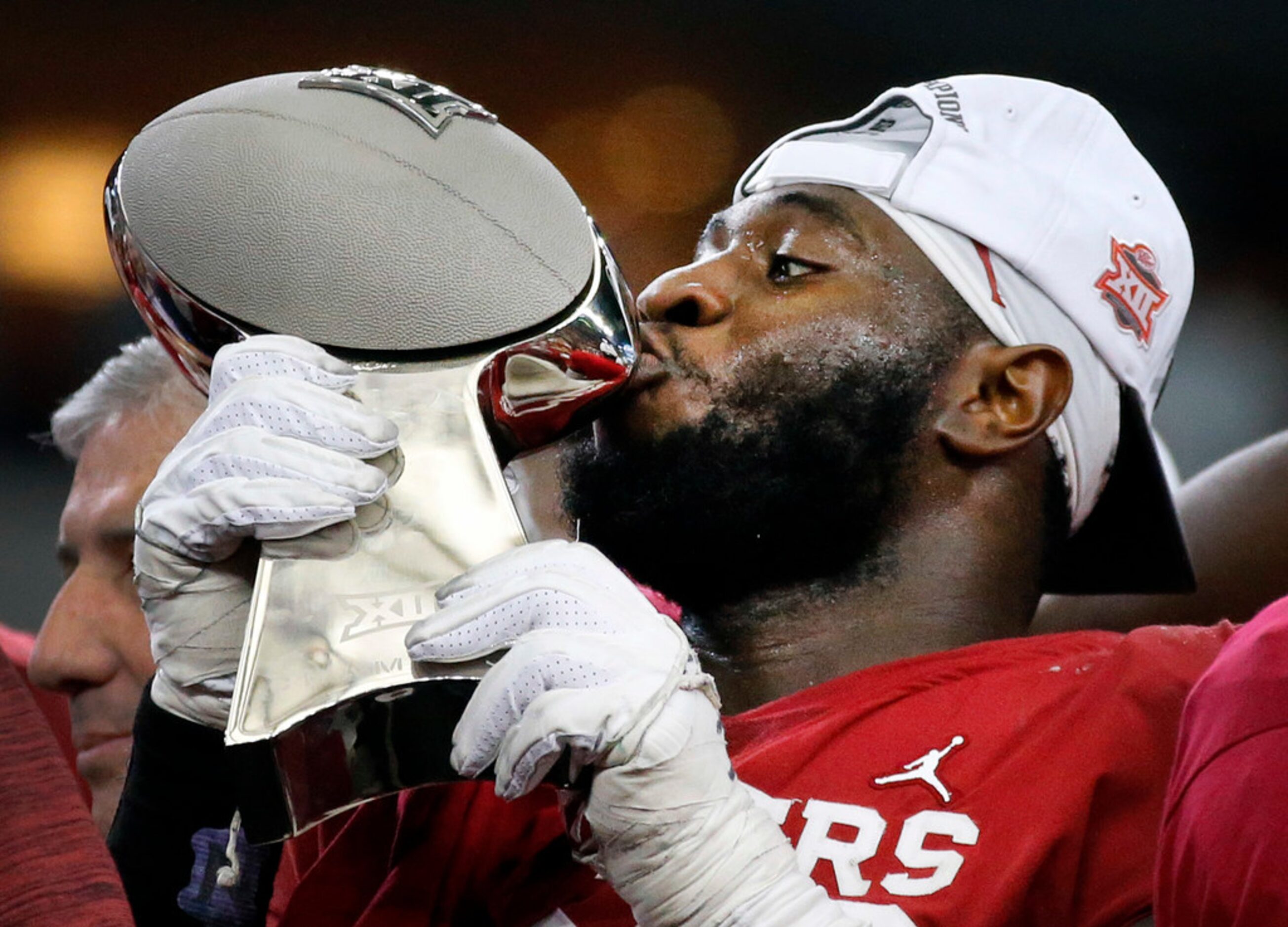 Oklahoma Sooners defensive lineman Neville Gallimore (90) kisses the Big 12 Championship...