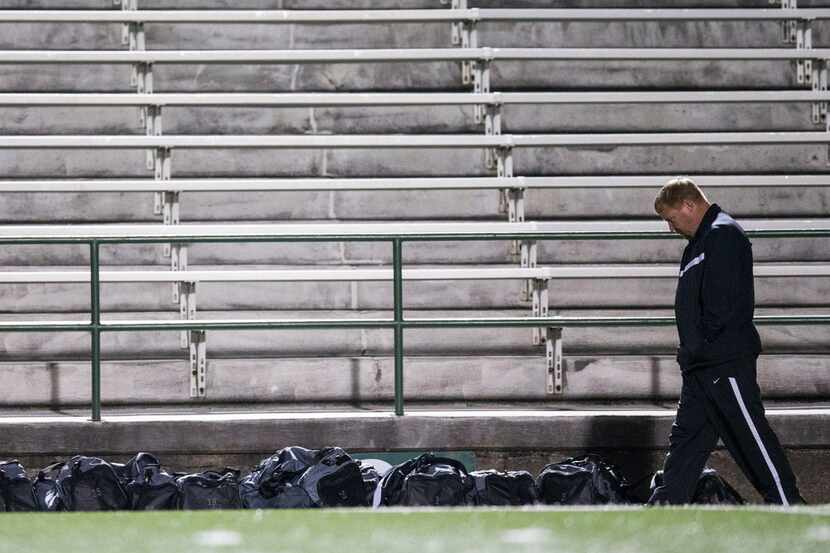 Forney High School soccer coach Kris Duplissey walks along the sideline during halftime of a...