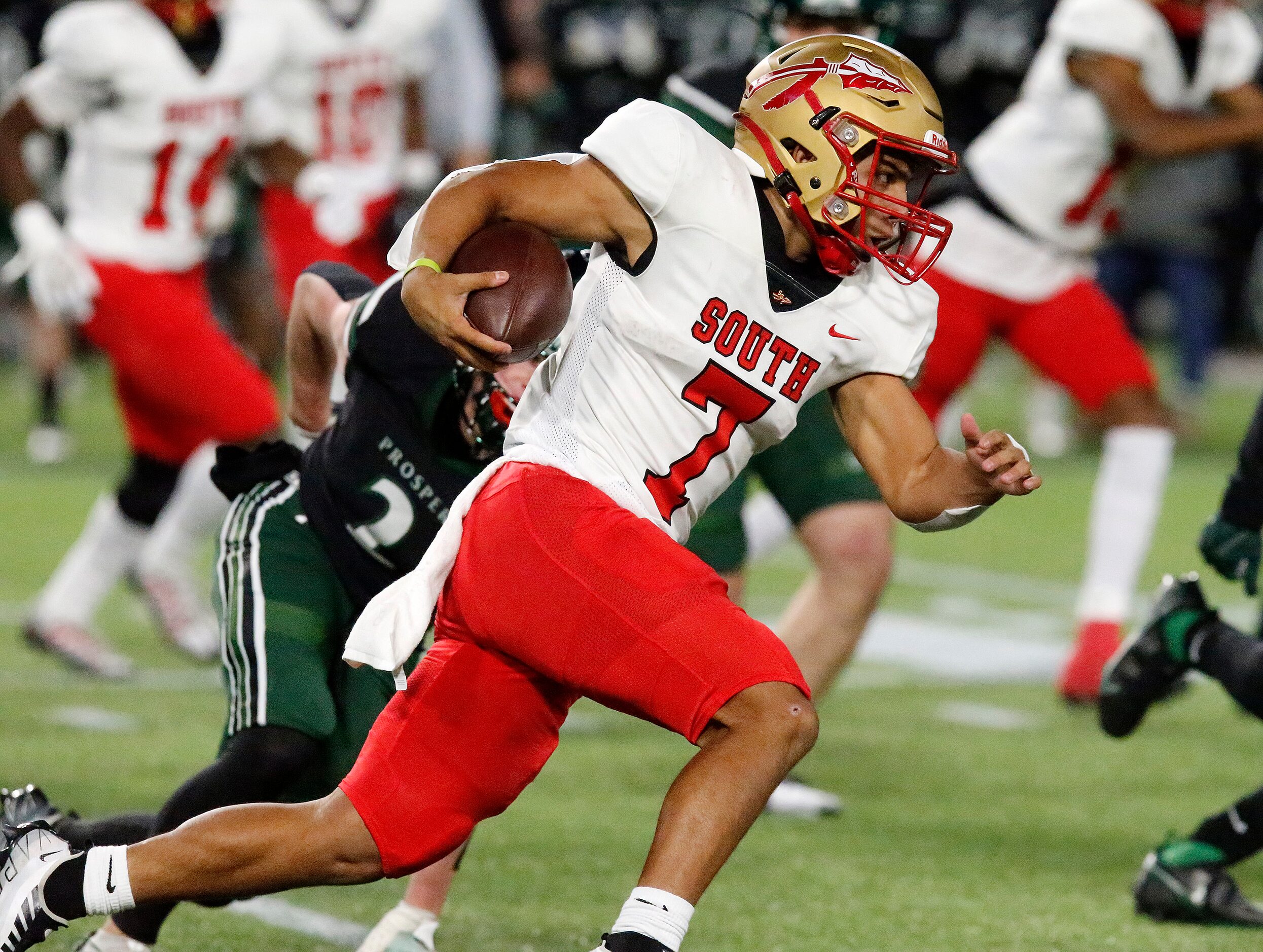 South Grand Prairie High School quarterback Jaden Stanley (7) keeps the ball on a run during...