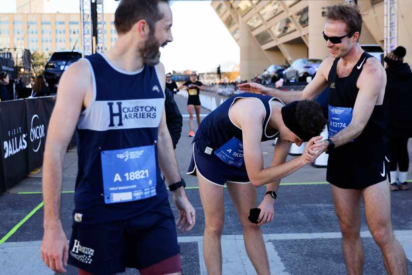 Half marathon runners congratulate each other after arriving at the finish line during 2023...