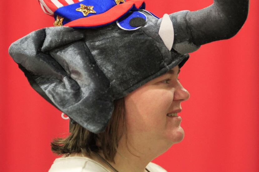 Tea party volunteer Margaret Foland wears an elephant hat as attendees arrive for the 2014...