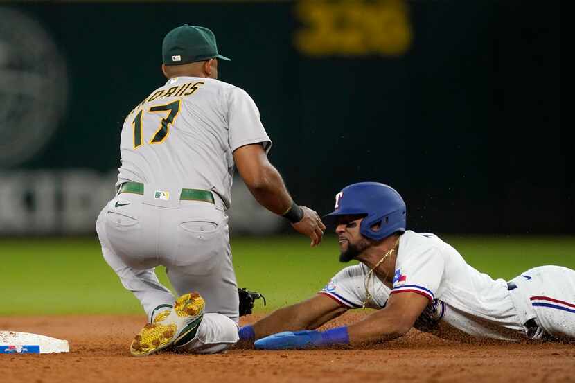 Oakland Athletics shortstop Elvis Andrus (17) reaches down to tag out Texas Rangers' Leody...