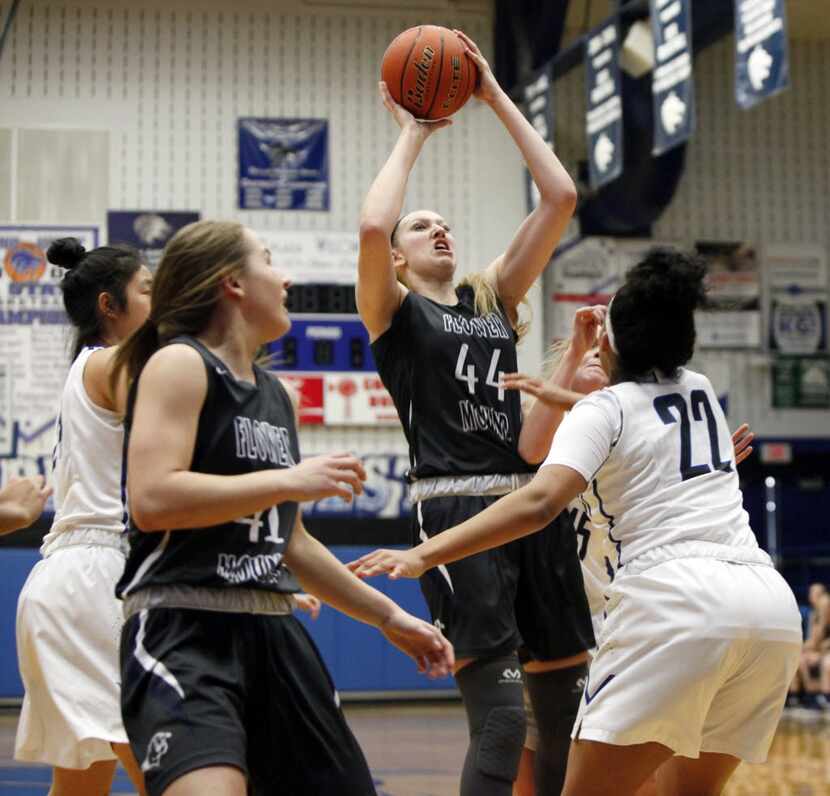 Flower Mound senior center Lauren Cox (44) attempts a jump shot while guarded by Plano West...