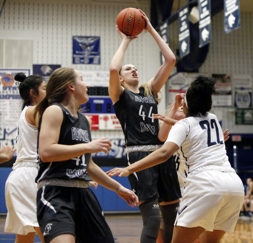 Flower Mound senior center Lauren Cox (44) attempts a jump shot while guarded by Plano West...