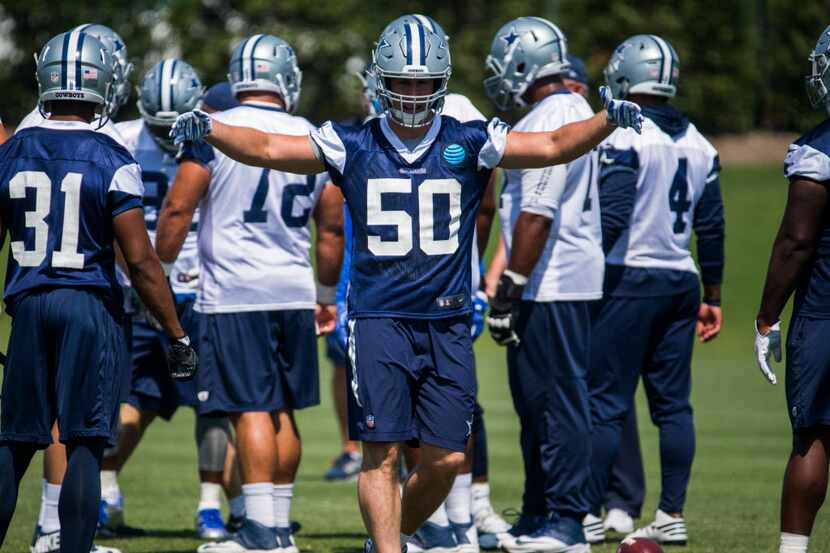 Dallas Cowboys outside linebacker Sean Lee (50) motions to defensive players during practice...