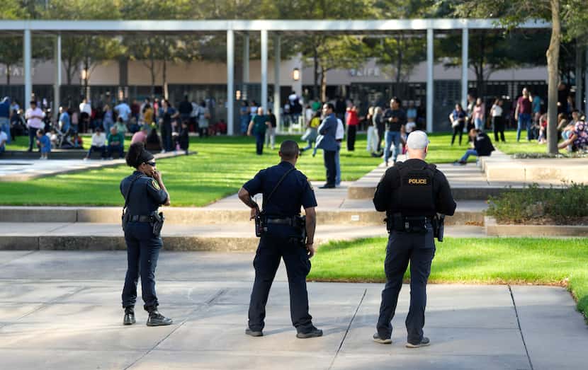 Houston Police officers watch over displaced churchgoers outside Lakewood Church, Sunday,...