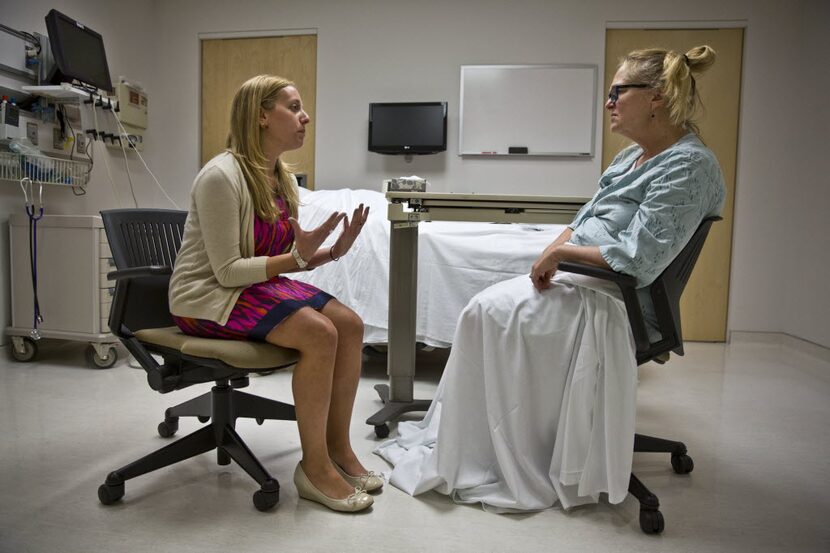 Intern doctor Jessica Kimmel, talks to Eileen Vorbach, who portrays a dying patient as part...