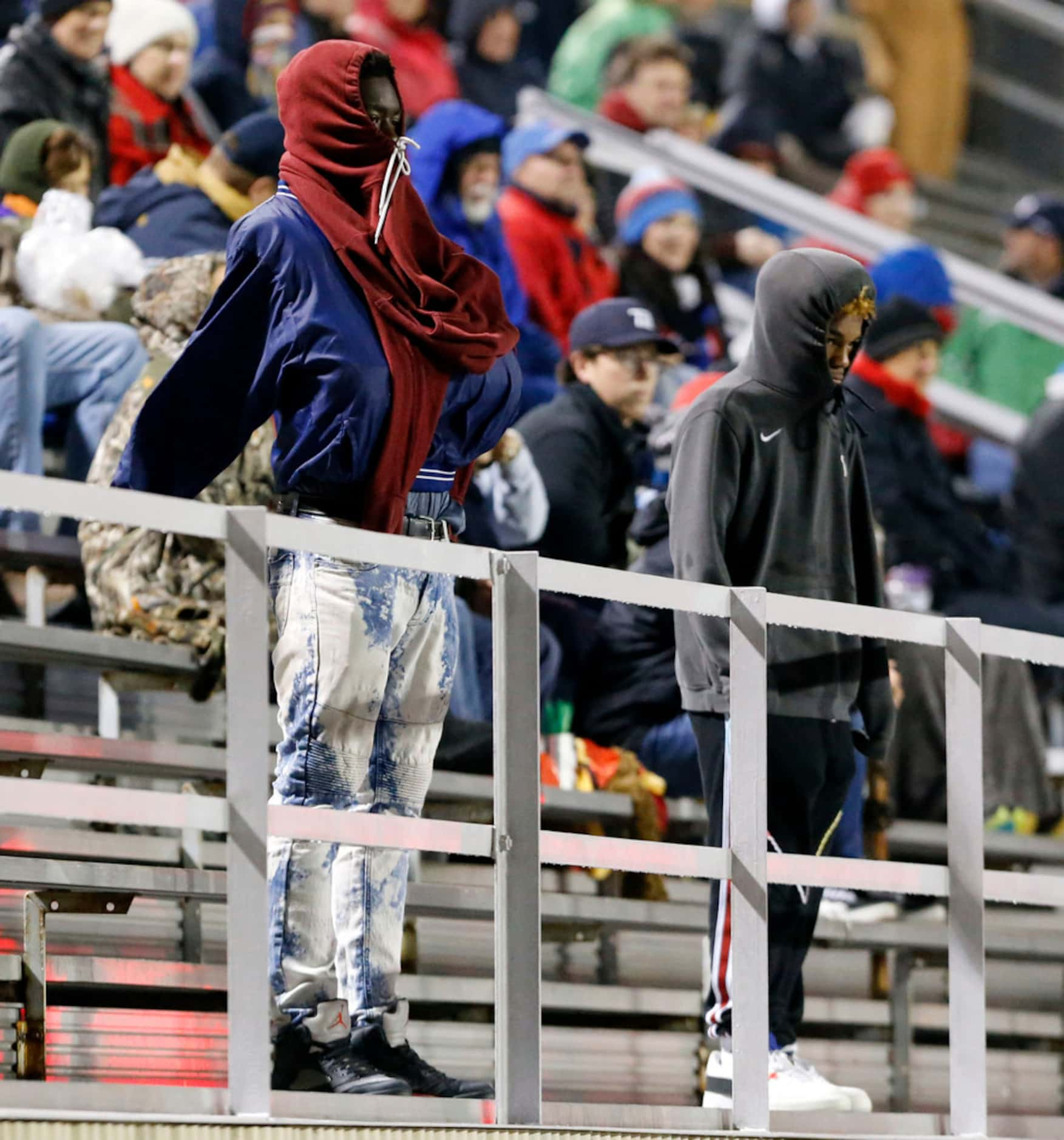 Richardson Pearce fans wrapped in hoodies watch the team fall behind in a cold drizzle...