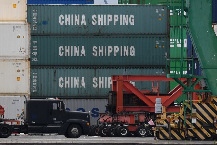 A container ship unloads its cargo at the main port terminal in Long Beach, California on...