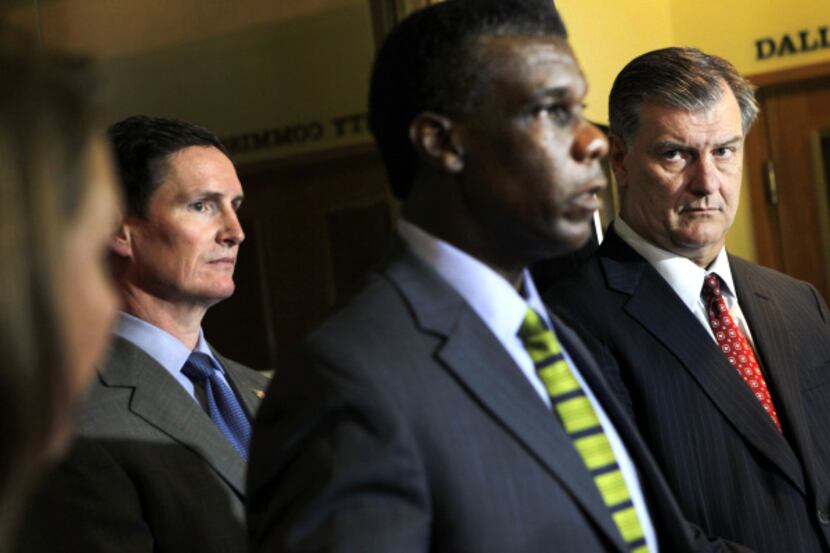 Dallas County Judge Clay Jenkins (left) and Dallas Mayor Mike Rawlings (far right) listen as...
