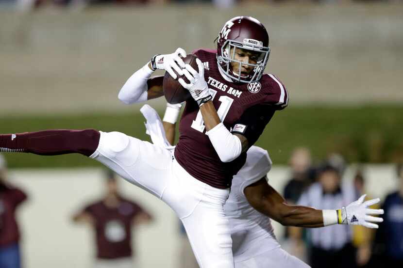 Texas A&M wide receiver Josh Reynolds (11) catches a touchdown pass in front a Rice defender...