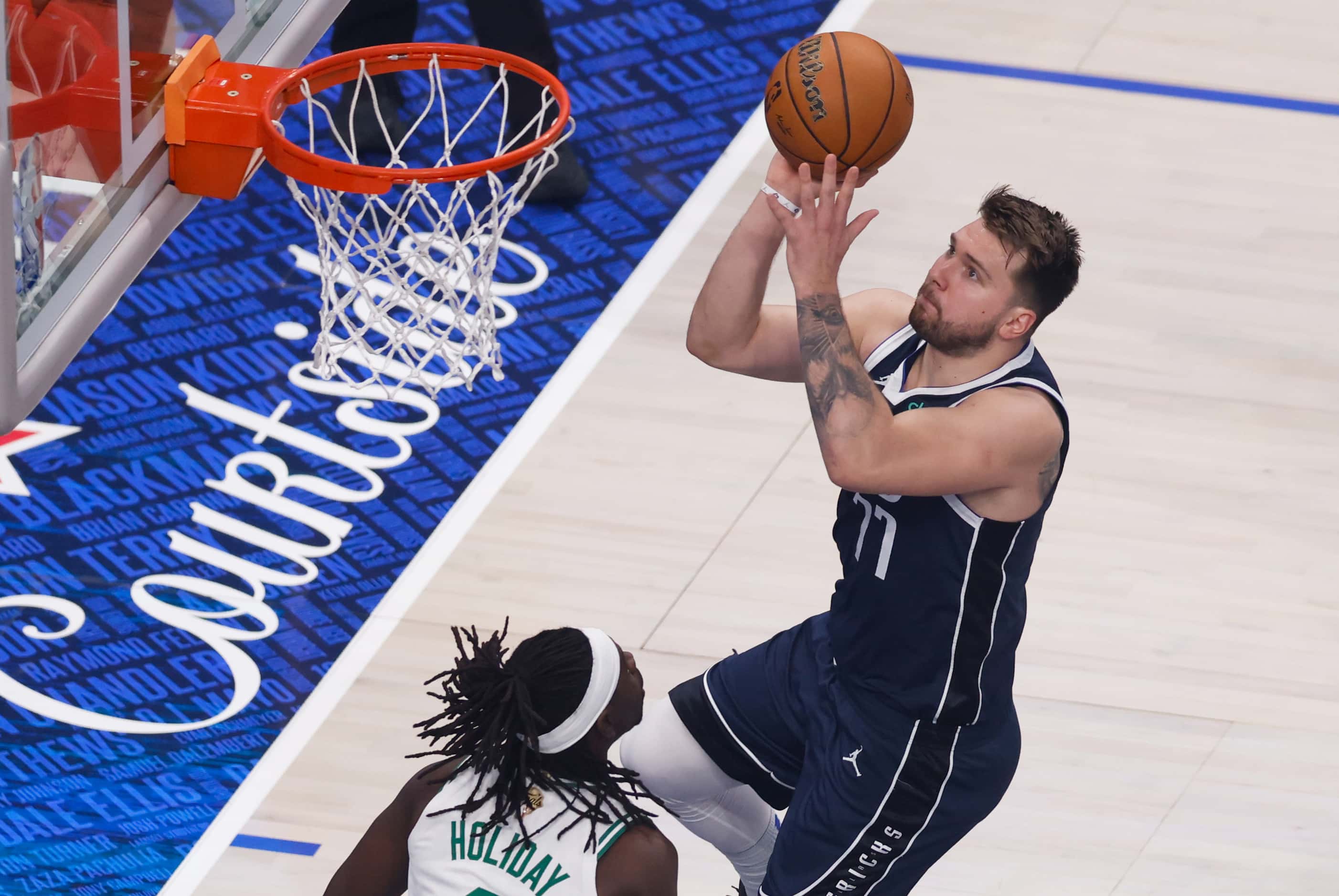 Dallas Mavericks guard Luka Doncic (77) attempts a layup over Boston Celtics guard Jrue...