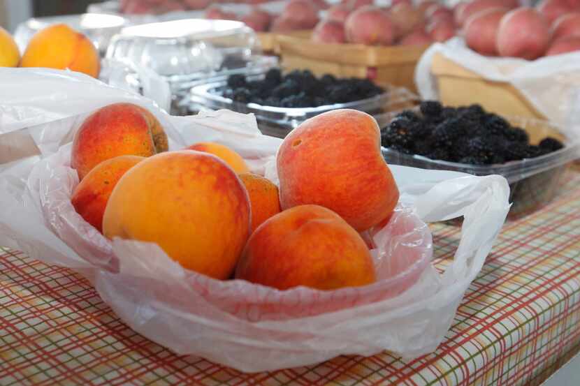 The Williams Farm booth in The Shed at Dallas Farmers Market offered peaches to market...