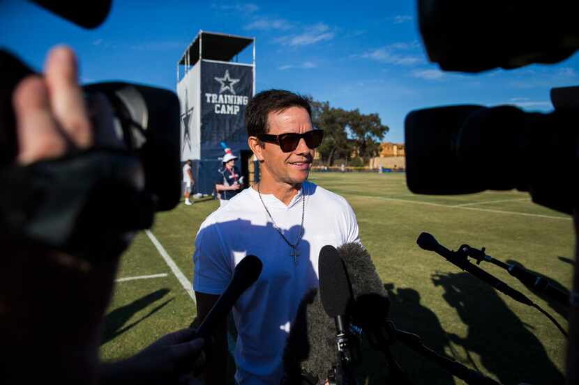 Actor and business man Mark Wahlberg speaks to reporters during an afternoon practice at...