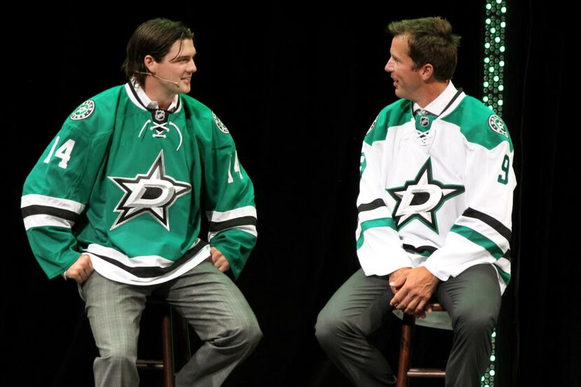 Current Dallas Stars player Jamie Benn, left, and former Stars great Mike Modano model the...