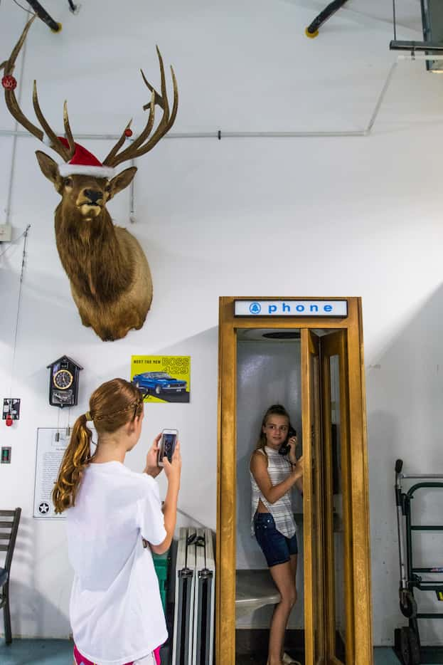 Alyson Dover, 13, left, takes a photograph of Maddison Drake, 13, both of Aledo, Texas, at...