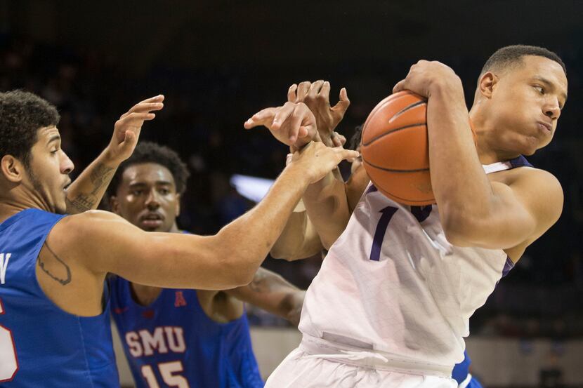 TCU guard Desmond Bane (1) maintains the ball from the SMU defense during a game at Moody...