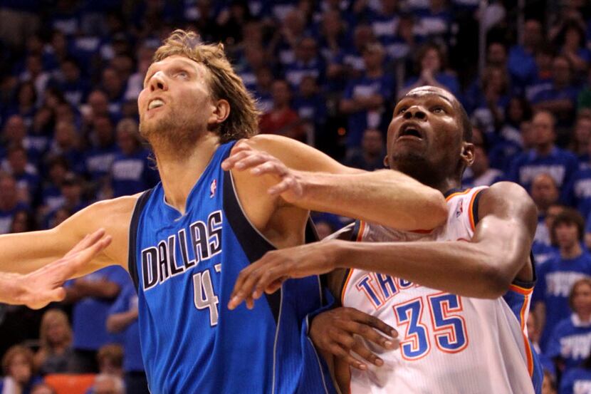 Dirk Nowitzki (41) jostles for rebounding position with Kevin Durant (35) during the second...
