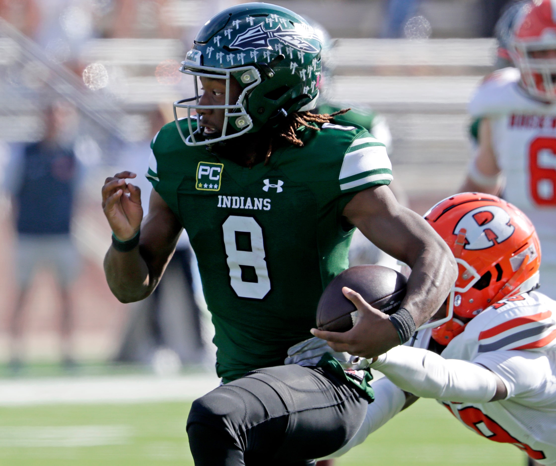 Waxahachie High School quarterback Ramon McKinney Jr. (8) runs through a tackle during the...