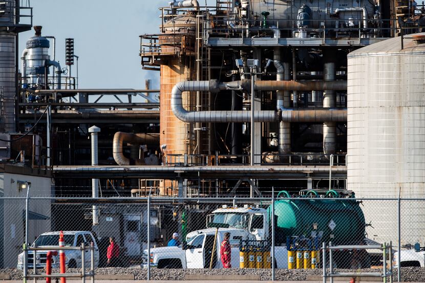 Workers stand in a lot at a LyondellBasell facility in La Porte. A chemical leak Tuesday...