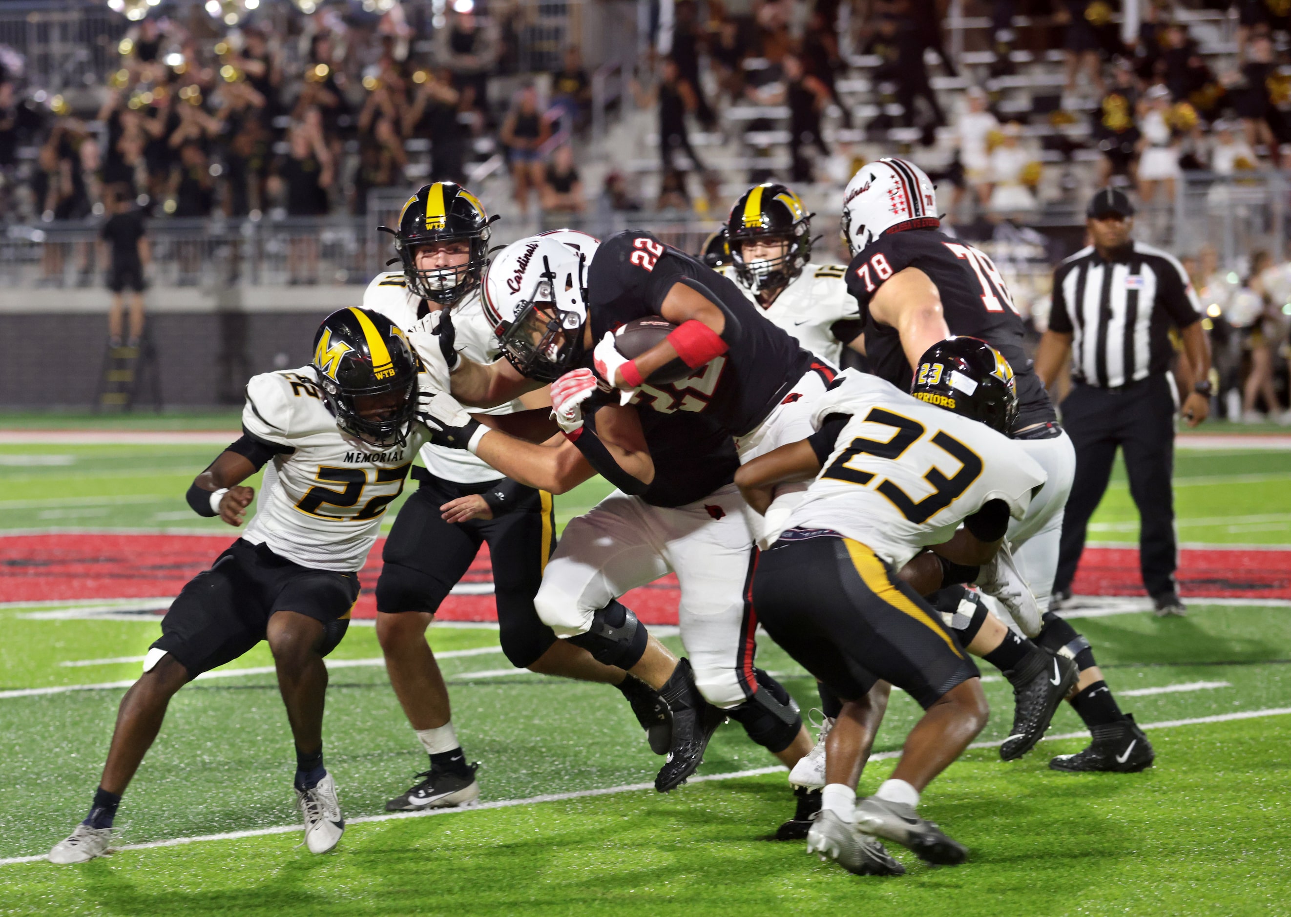 Melissa player #22 Jeremiah Tabor is stopped by a wall of Memorial players as he runs the...