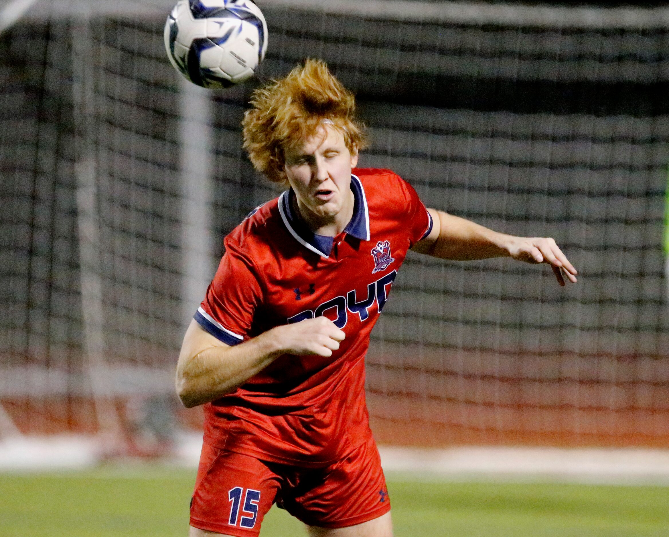 McKinney Boyd High School defender Jason Hoyle (15) gets a header during the first half as...