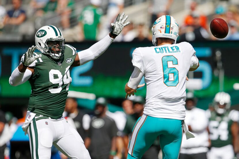 EAST RUTHERFORD, NJ - SEPTEMBER 24: Jay Cutler #6 of the Miami Dolphins has his pass attempt...