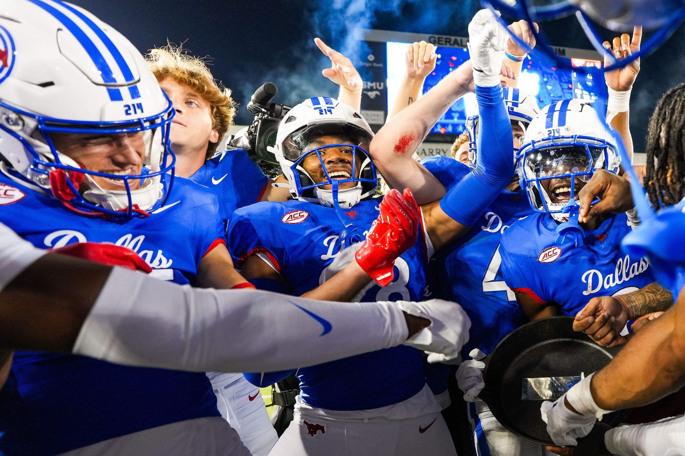 SMU players celebrate with the Iron Skillet trophy after a 66-42 victory over TCU in an NCAA...