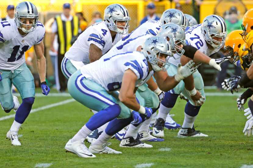 Dallas Cowboys quarterback Dak Prescott (4) takes the snap as receiver Cole Beasley (11)...