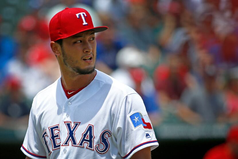 Texas Rangers starting pitcher Yu Darvish (11) walks back to the dugout during the second...