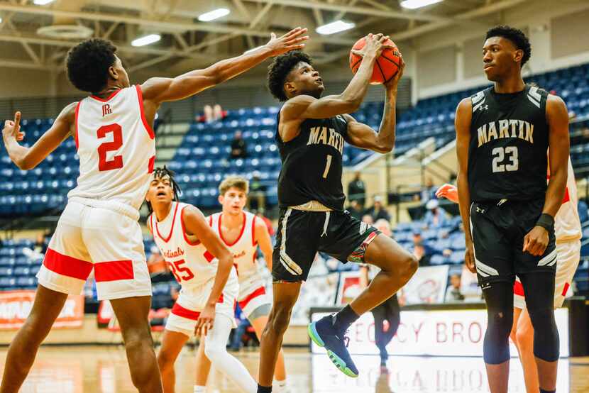 Arlington Martin Warrior' Jeremiah Charles (1) goes for a shot against John Paul II...