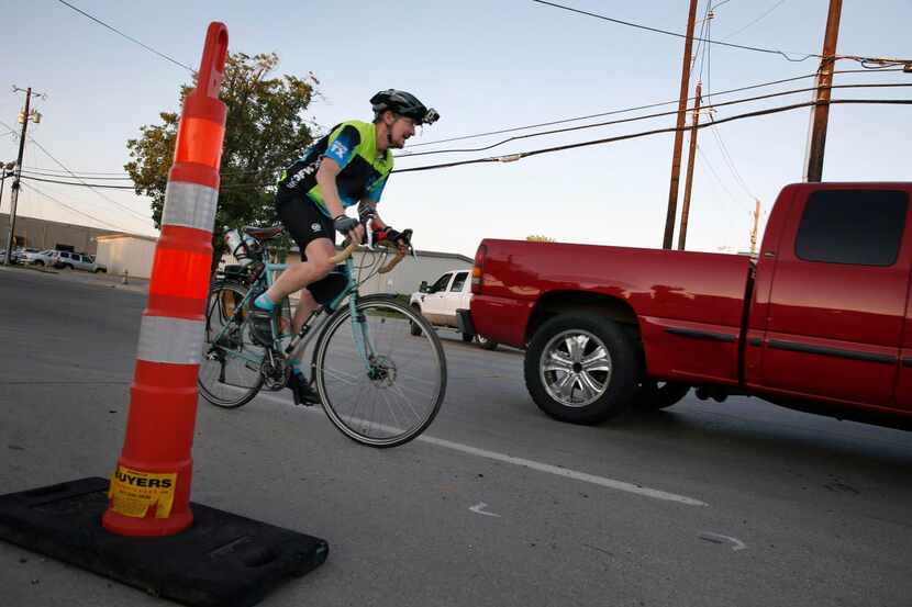 
Mike McNair, who bikes 26 miles from his home in Garland to his Irving workplace, navigates...