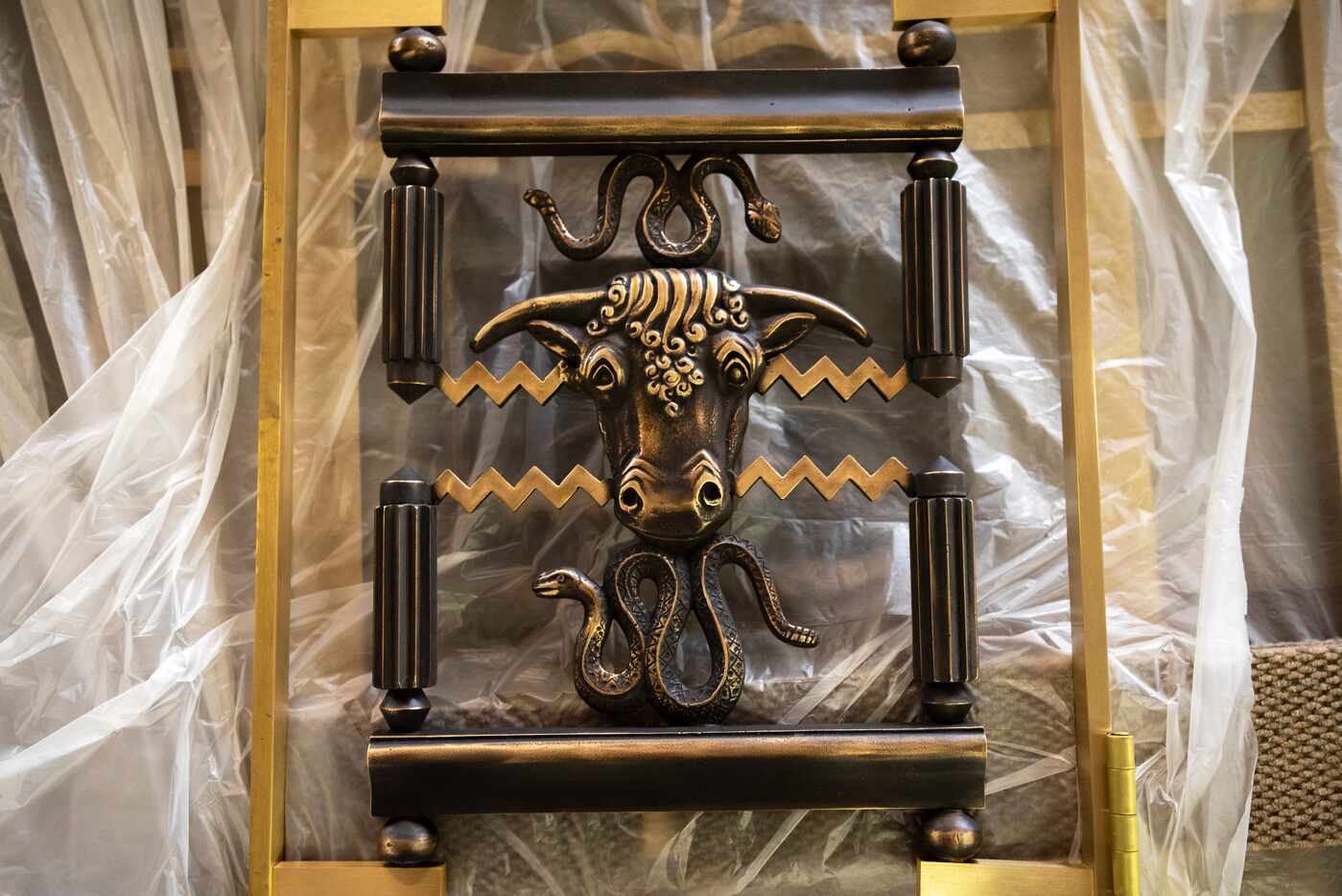 A piece from one of the disassembled entry door grills being restored in Michael van Enter's...