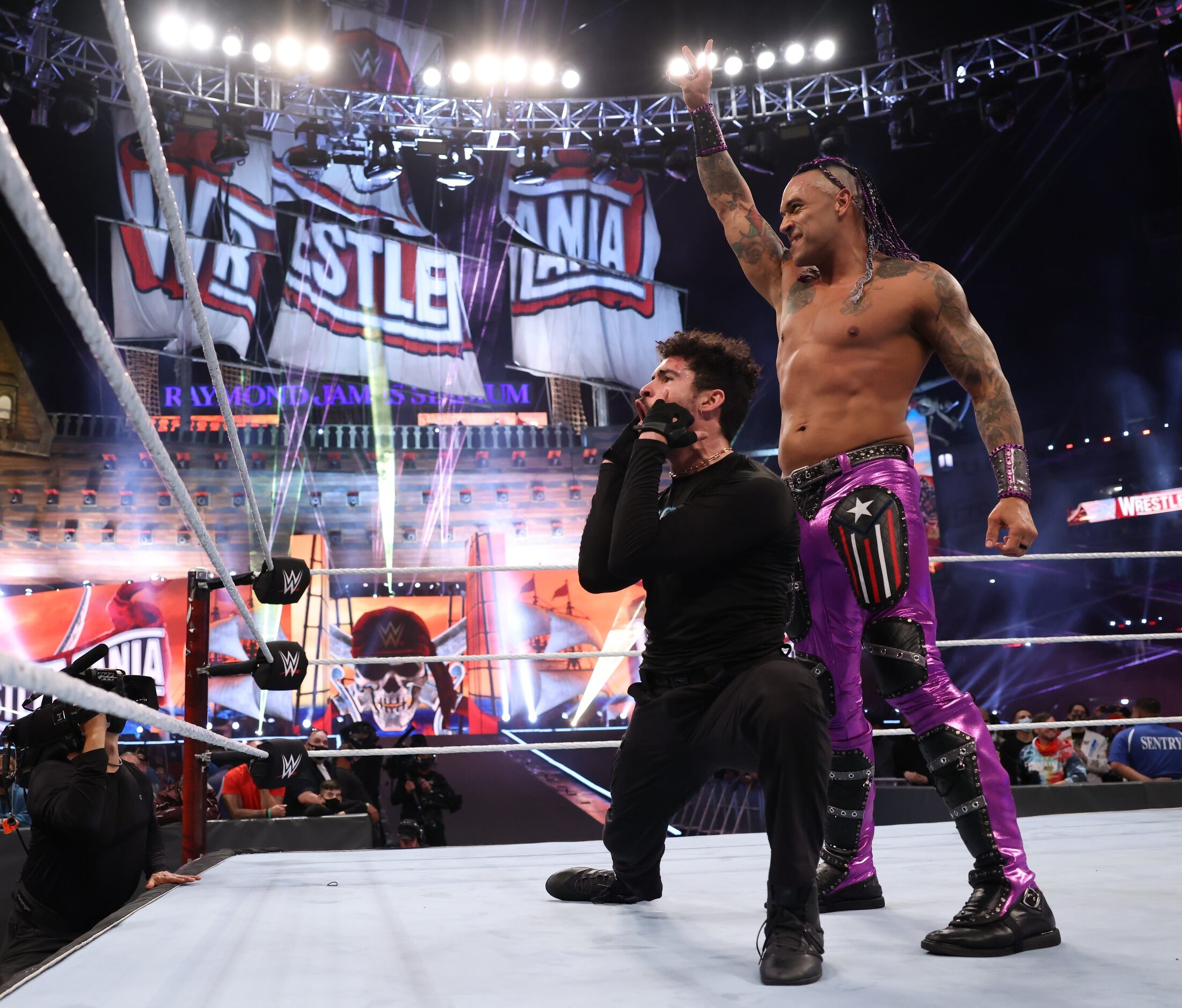 WWE's Damian Priest and rapper Bad Bunny celebrate following their win at WrestleMania 37 in...