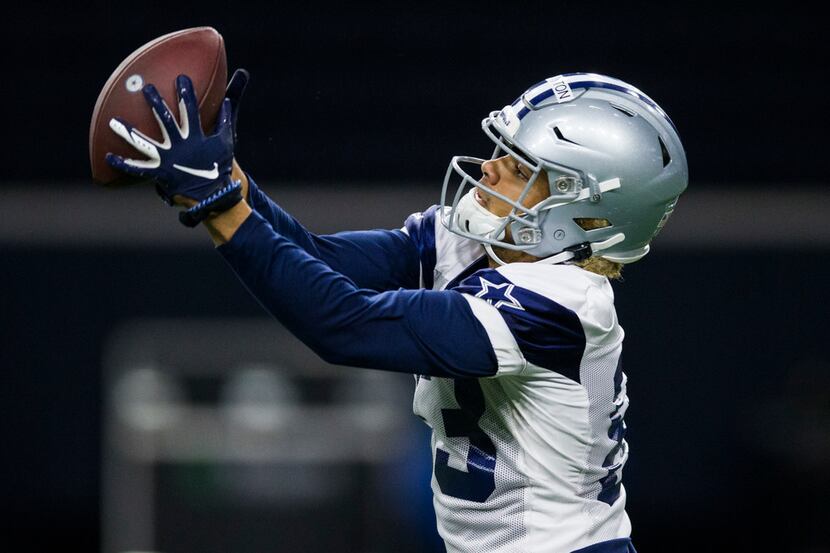 Cowboys wide receiver Jalen Guyton (83) makes a catch during OTAs on Wednesday, May 29,...
