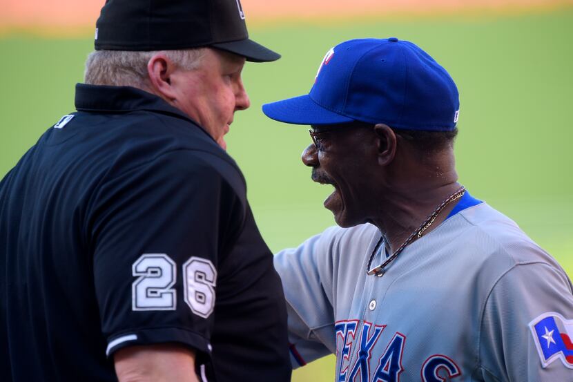Texas Rangers manager Ron Washington, right, argues with home plate umpire Bill Miller after...