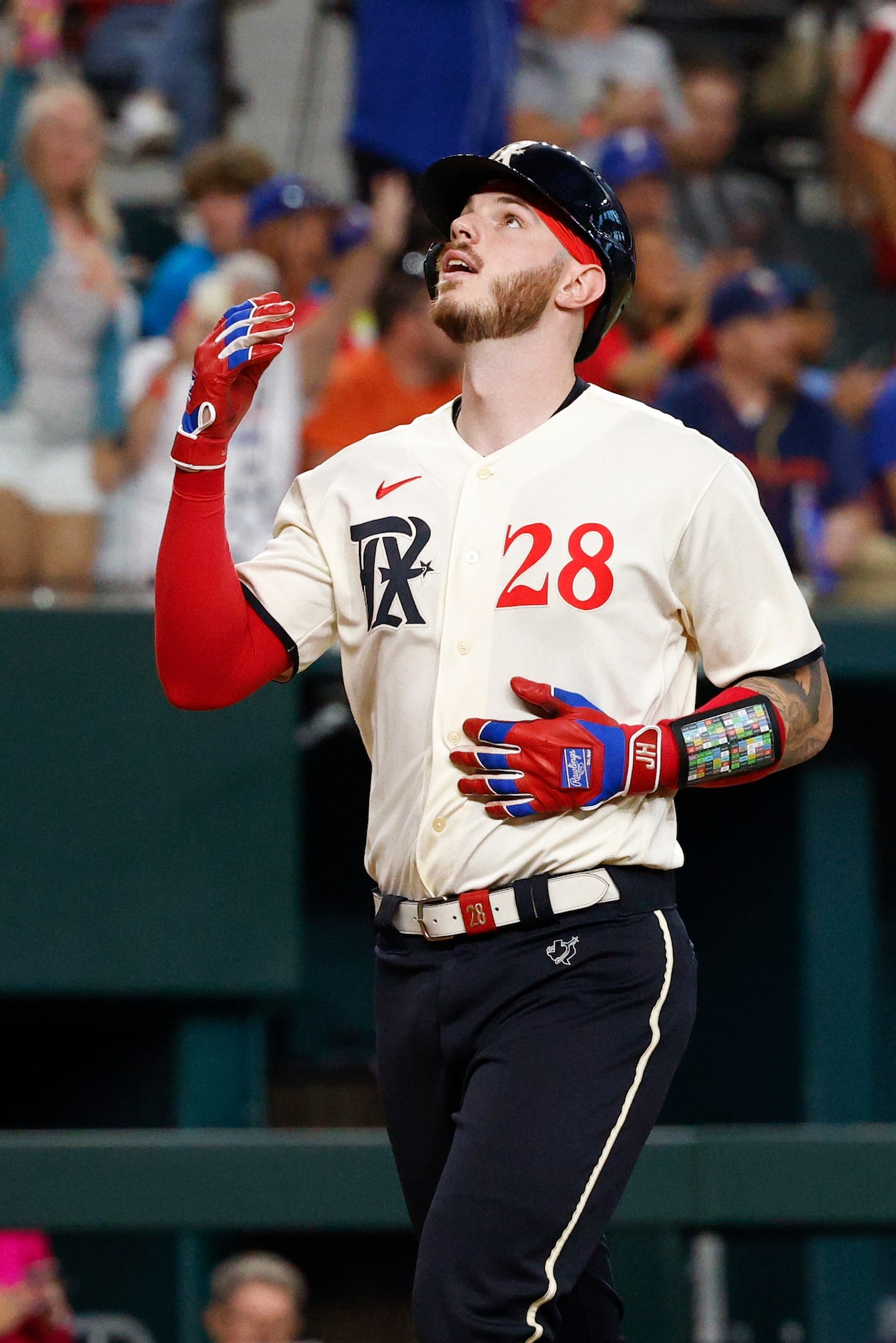 Texas Rangers catcher Jonah Heim (28) celebrates his home run as he crosses home plate...