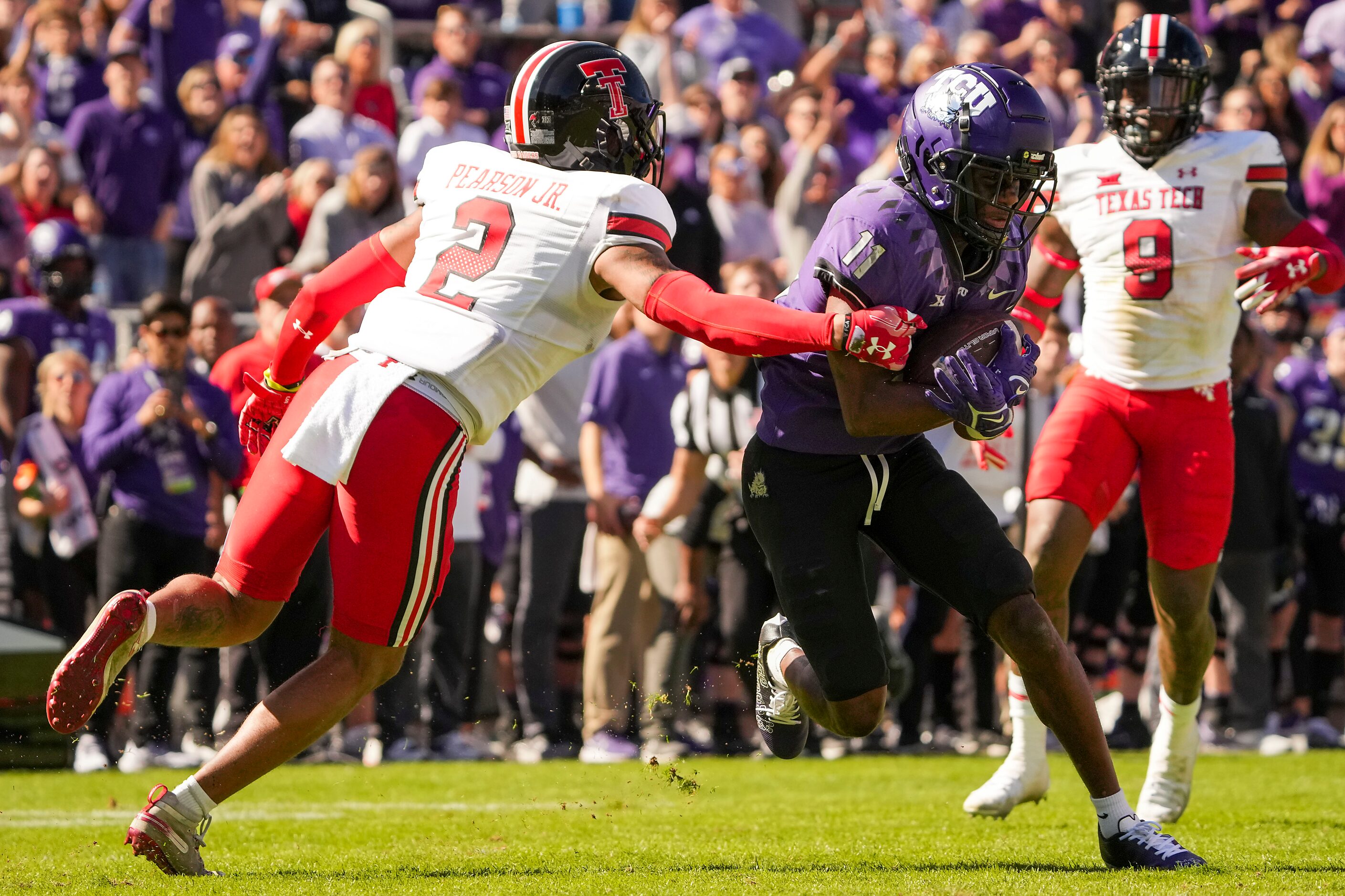 TCU wide receiver Derius Davis (11) catches a touchdown pass as Texas Tech defensive back...