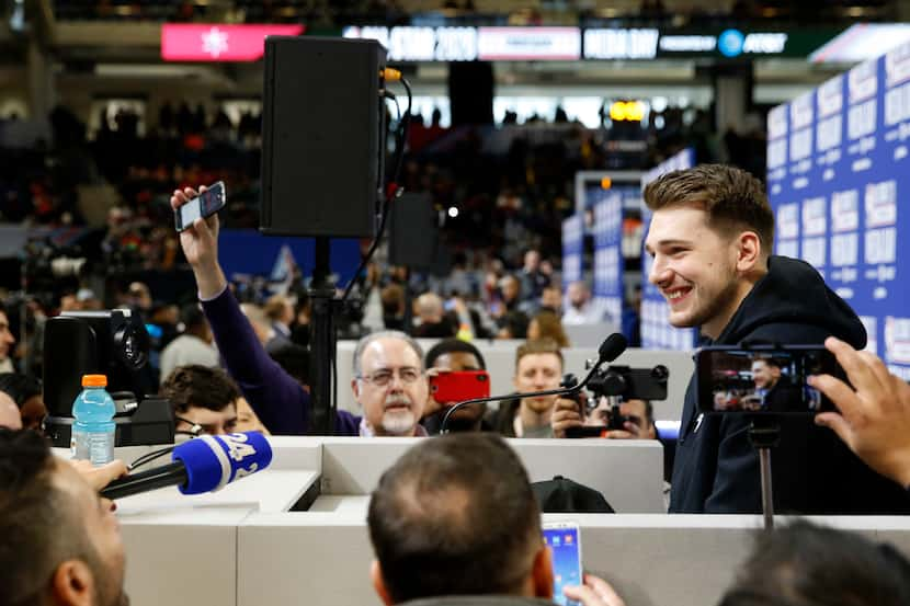 Team LeBron's Dallas Mavericks forward Luka Doncic (2) smiles as he answers questions from...