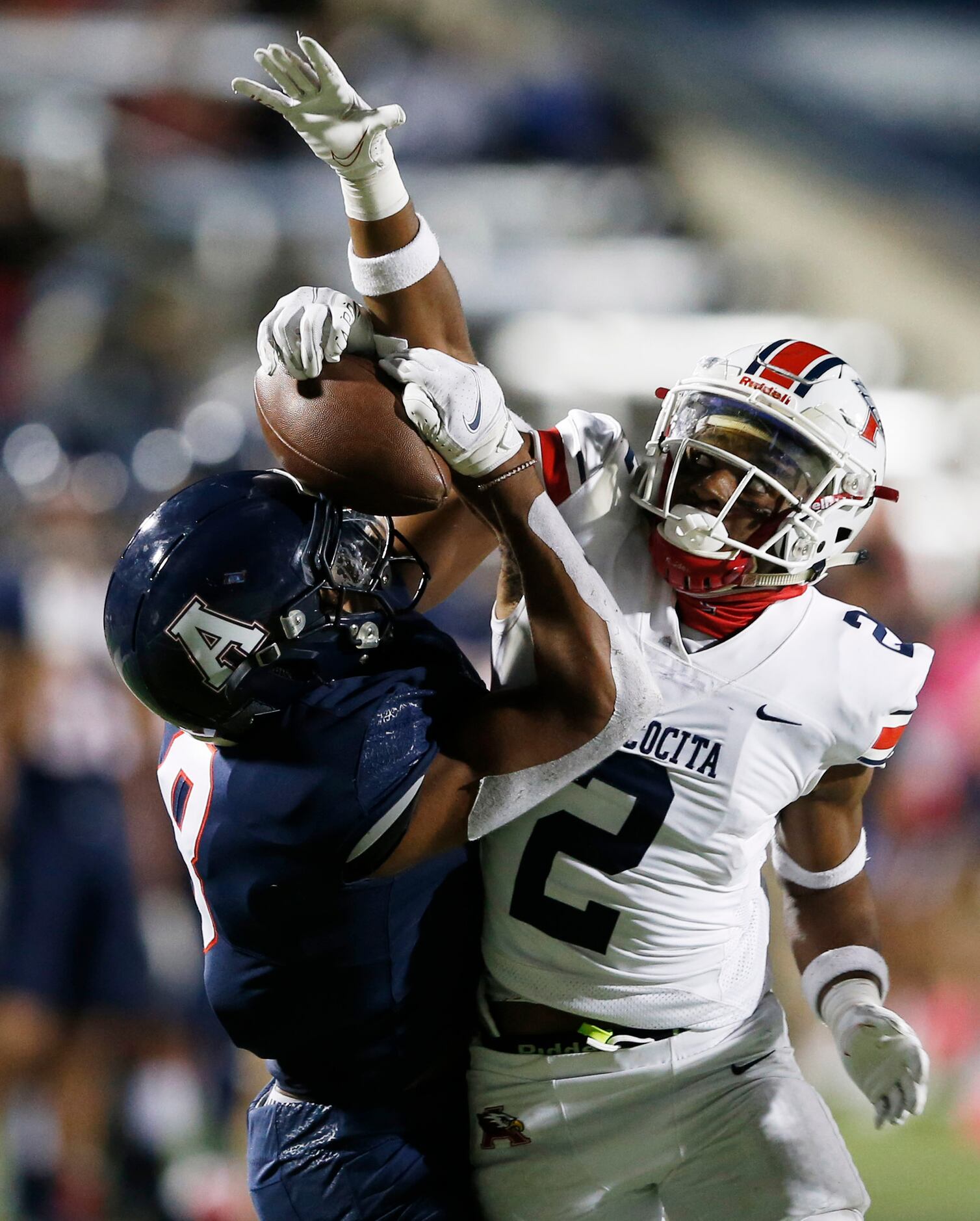 Allen's Blaine Green (8) gets the ball knocked out of his hands by Humble Atascocita's Caleb...