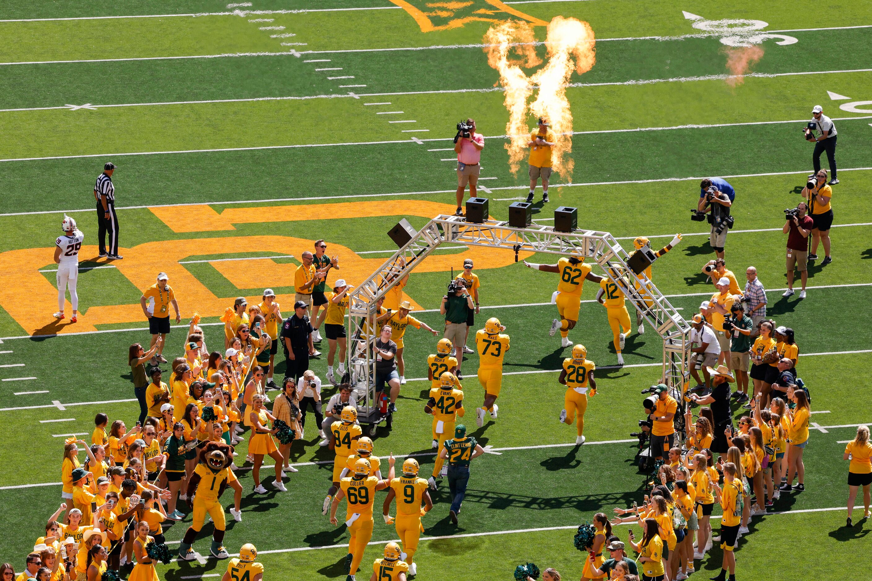 Baylor students cheer players as they take the field before an NCAA football game between...