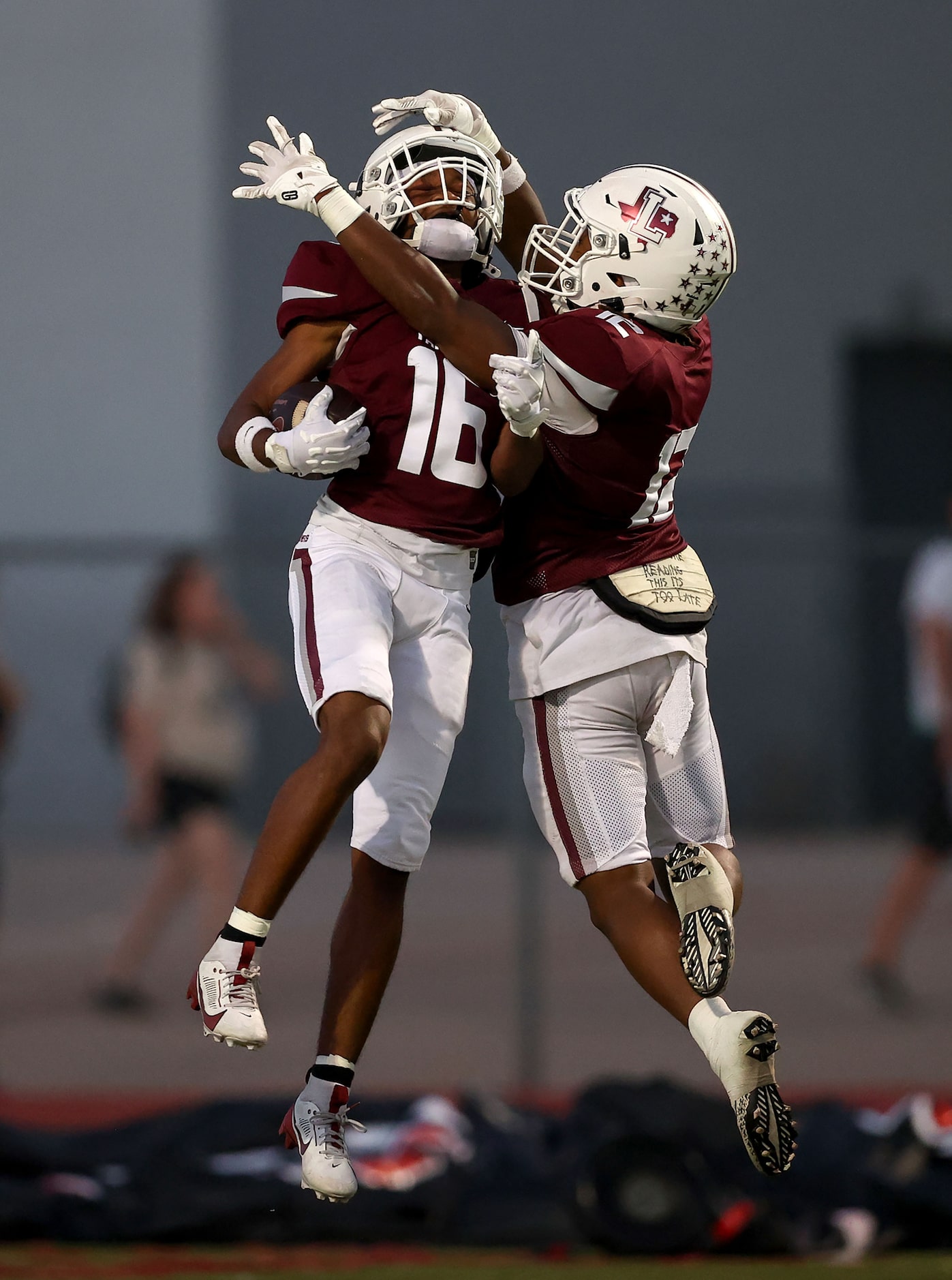 Lewisville wide receiver JT Thomas (16) celebrates with Derrick Martin (12) after his...